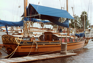 Sails down, awning up for sailboat